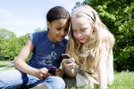 Girls playing with cell phones   Original Filename: kids texting.jpg