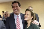 Republican presidential candidate and former U.S. Senator Santorum celebrates with his wife Karen as they hear Iowa Caucus voting results at a caucus rally in Johnston, Iowa